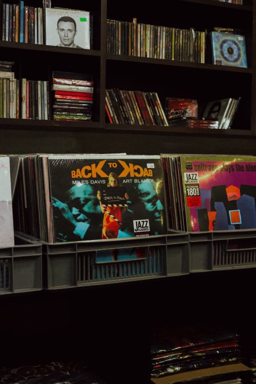 Free Classic jazz vinyl records displayed in a cozy music shop setting featuring iconic album covers. Stock Photo