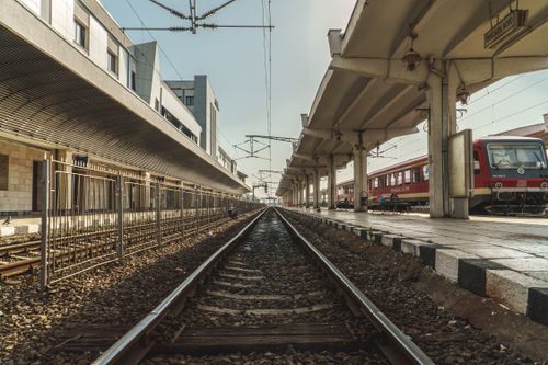 Free View of an empty railway platform at an urban train station on a clear day, showcasing infrastructure. Stock Photo