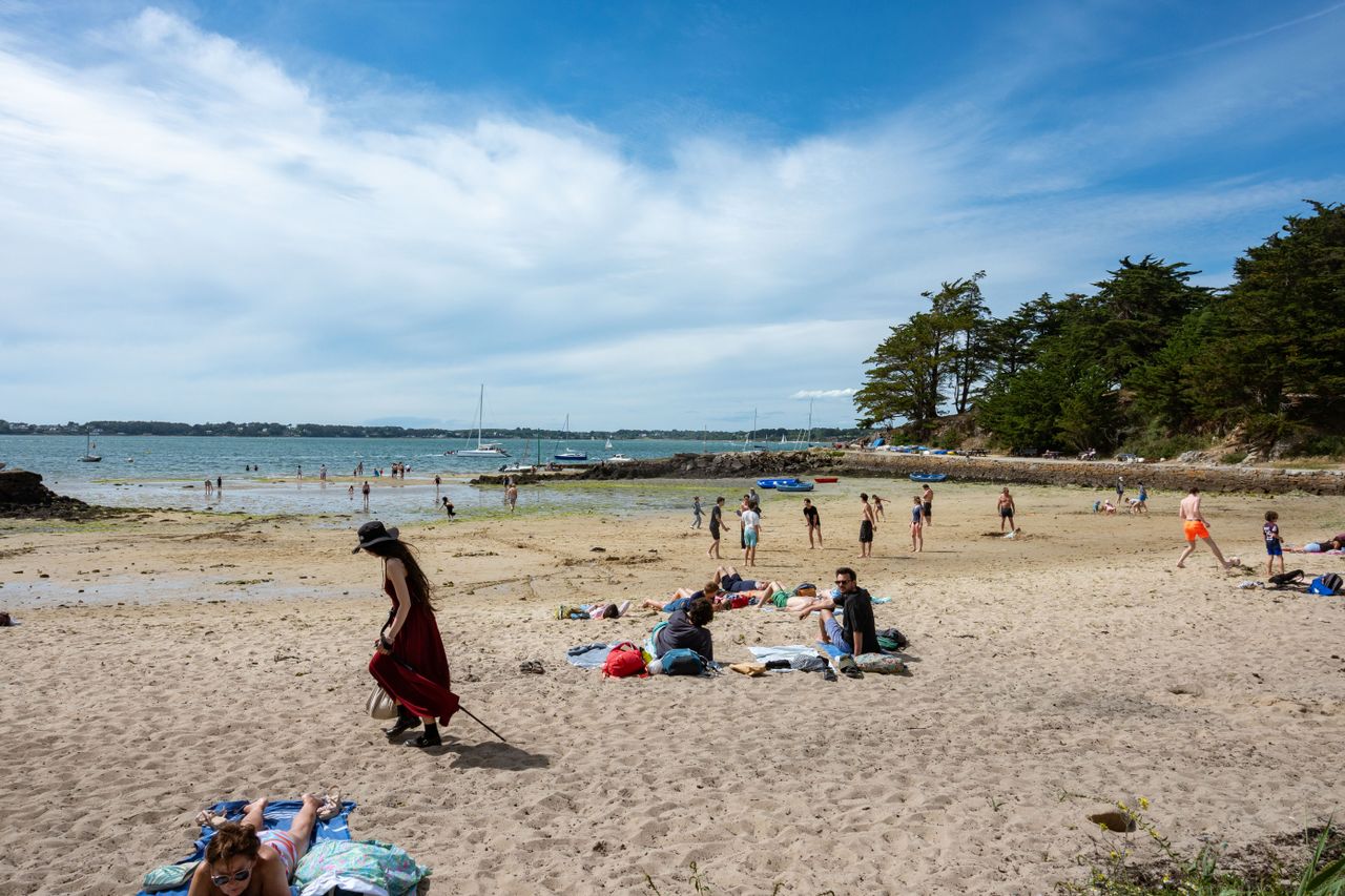 a lively summer day on a beach in brittany france with people enjoying