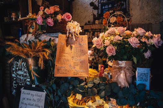 Charming café counter adorned with floral decor, handwritten menu, and rustic aesthetics.