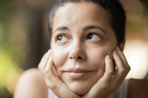 Woman With Both Hands on Her Chin