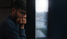 Thoughtful Man Looking Out Rainy Window