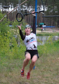 A woman navigating an outdoor obstacle course, showcasing strength and agility.