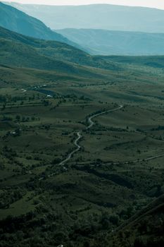 Aerial view of lush green hills and winding paths in Erzincan, showcasing nature's beauty.