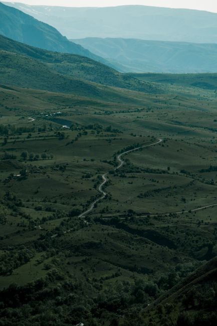 Aerial view of lush green hills and winding paths in Erzincan, showcasing nature's beauty.