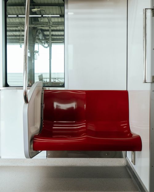 Free A sleek red train seat in a modern transportation setting at Rangsit, Pathum Thani, Thailand. Stock Photo