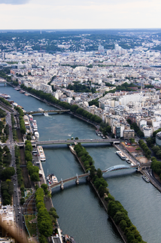 Stunning aerial photo showcasing Paris cityscape with the Seine River and iconic bridges.