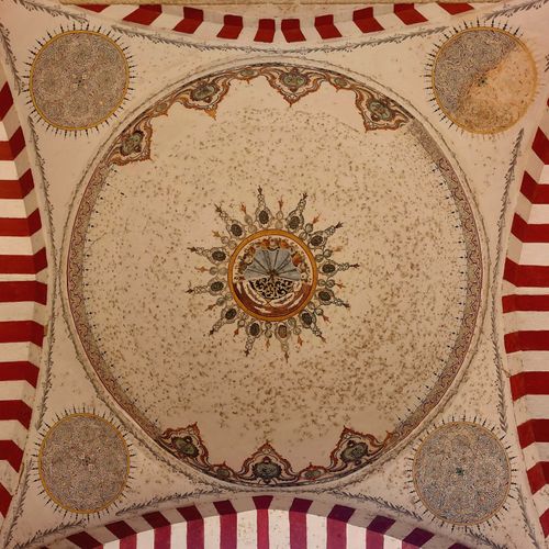 Free Explore the artistic details of an Ottoman dome ceiling with colorful geometric patterns and historical artwork. Stock Photo