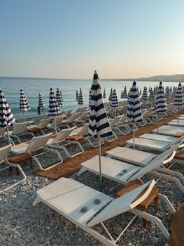 Aesthetic Beach View with Sunbeds and Umbrellas in Nice, France
