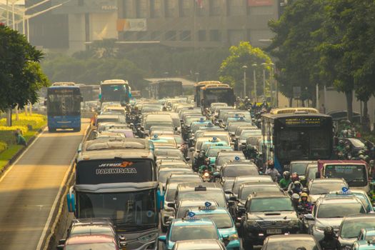 Heavy traffic jam in Jakarta's congested streets during daytime, showcasing urban life challenges.