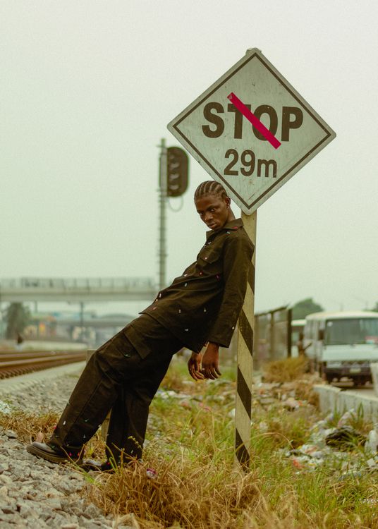 Lean Stop Sign Young Man Leaning on Stop Sign by Railroad · Free Stock Photo