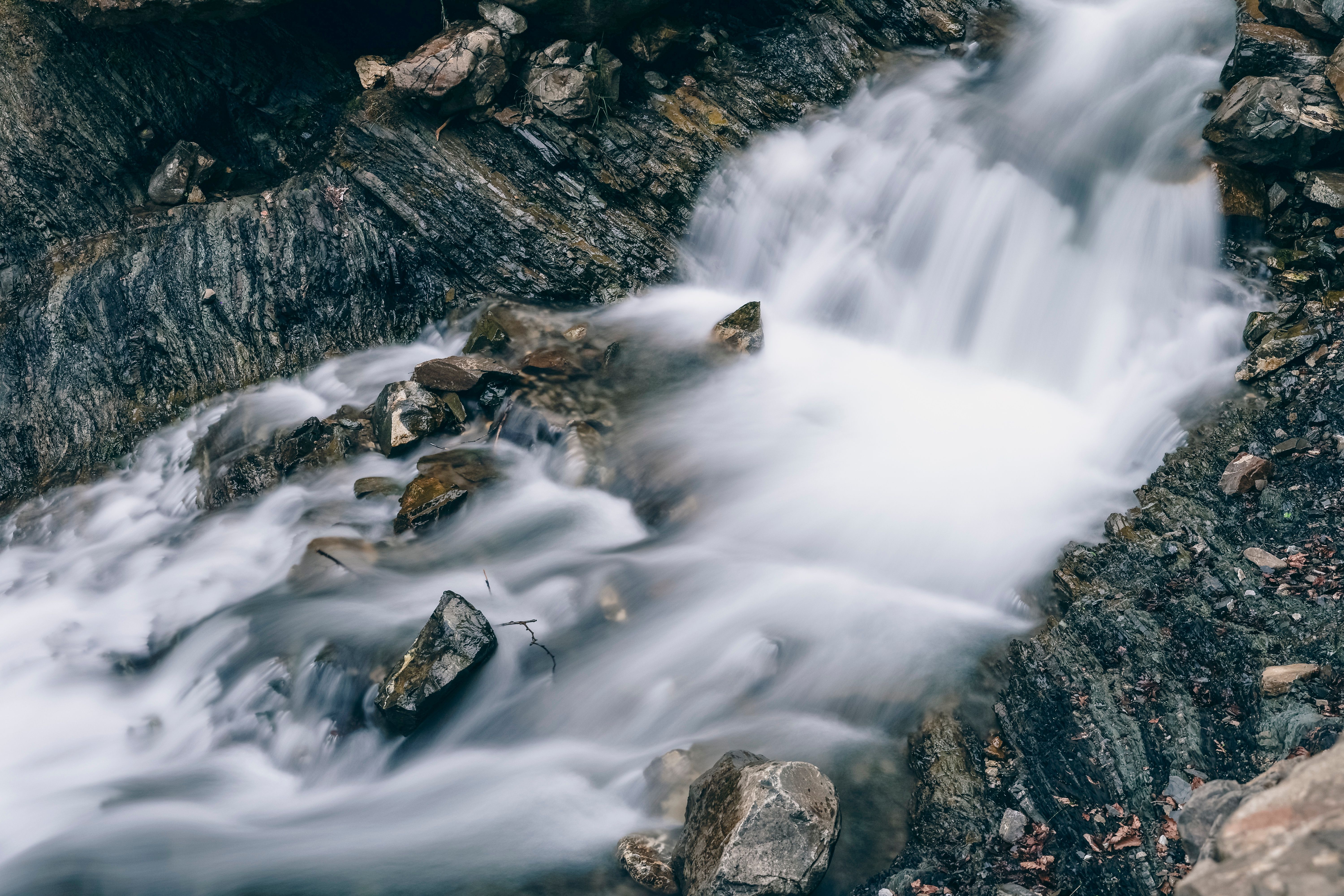 Tranquil view of a flowing mountain stream over rocks in Oberstdorf, Germany.