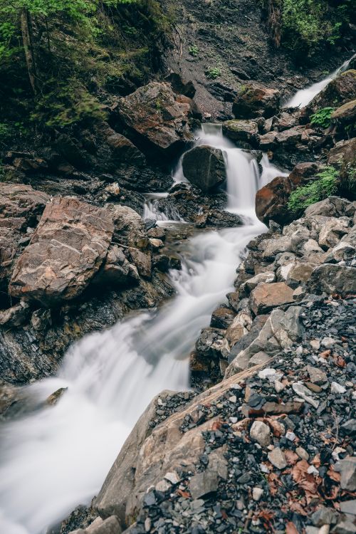 Free Experience the mystical beauty of an alpine waterfall cascading through rocks in Oberstdorf, Germany. Stock Photo