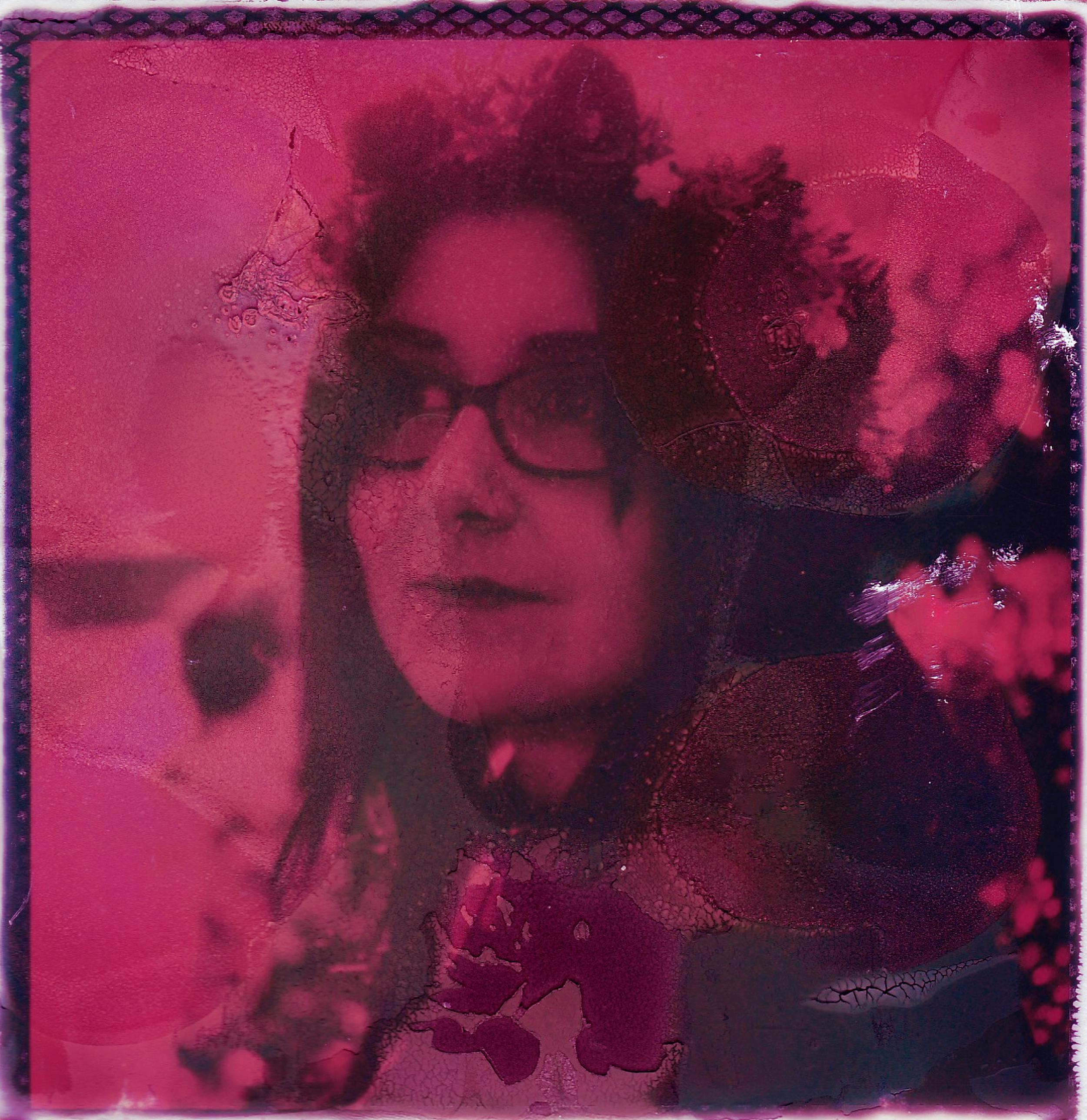 Creative pink-tinted portrait in instant film style, conveying a nostalgic and dreamy atmosphere.