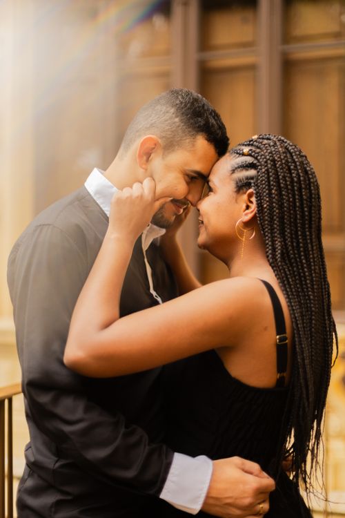 Free A loving couple shares an intimate moment indoors, enveloped in a warm glow, capturing romantic joy. Stock Photo