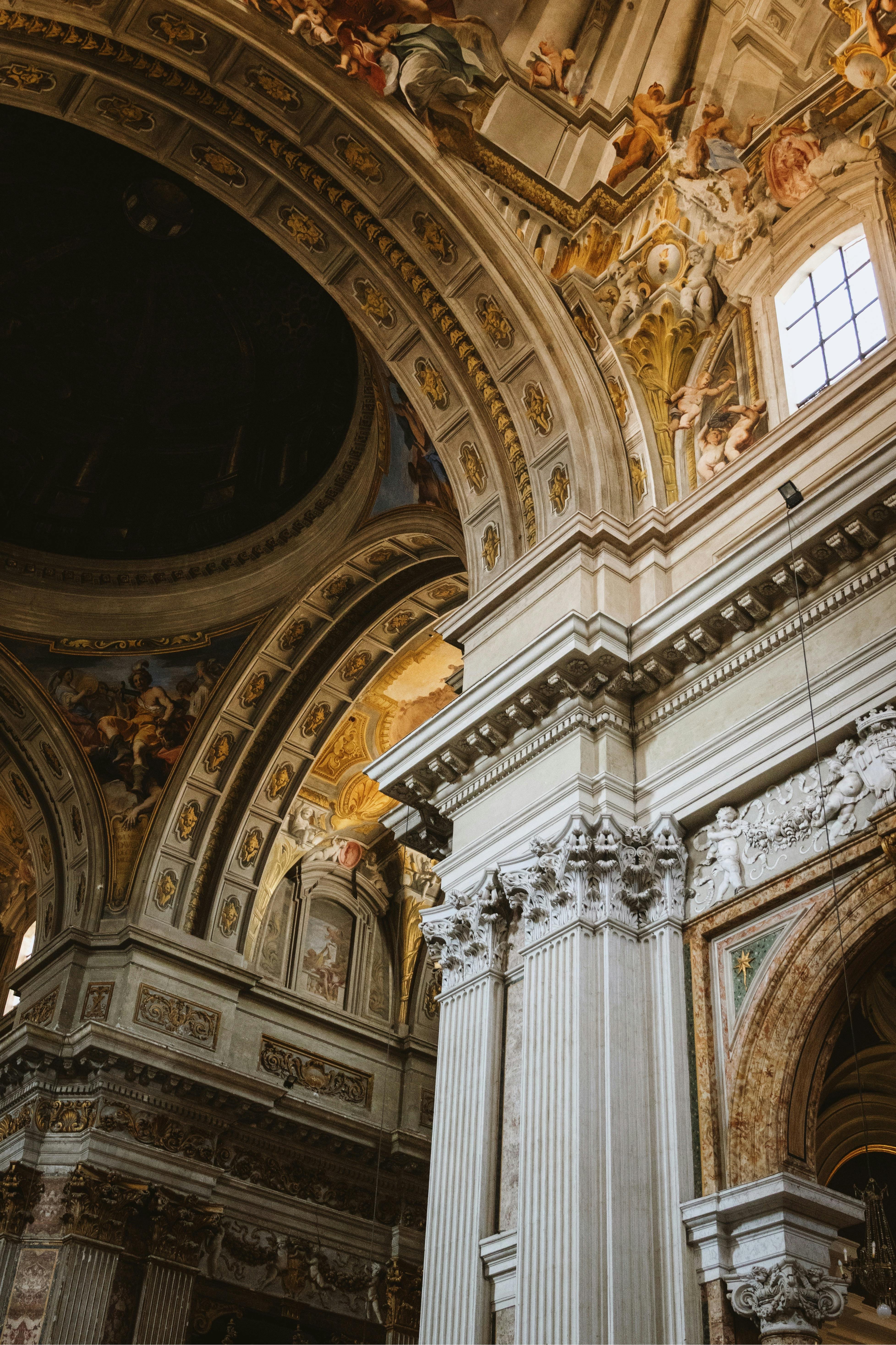 Stunning view of a lavishly decorated church ceiling in Rome, Italy showcasing intricate architectural design.