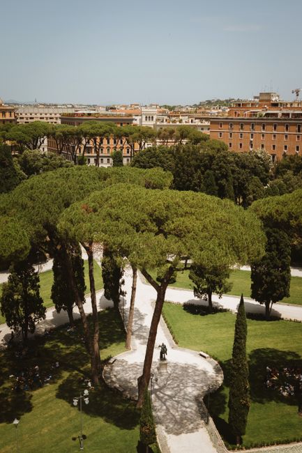 Aerial view of lush green park with winding paths in Rome, Italy.