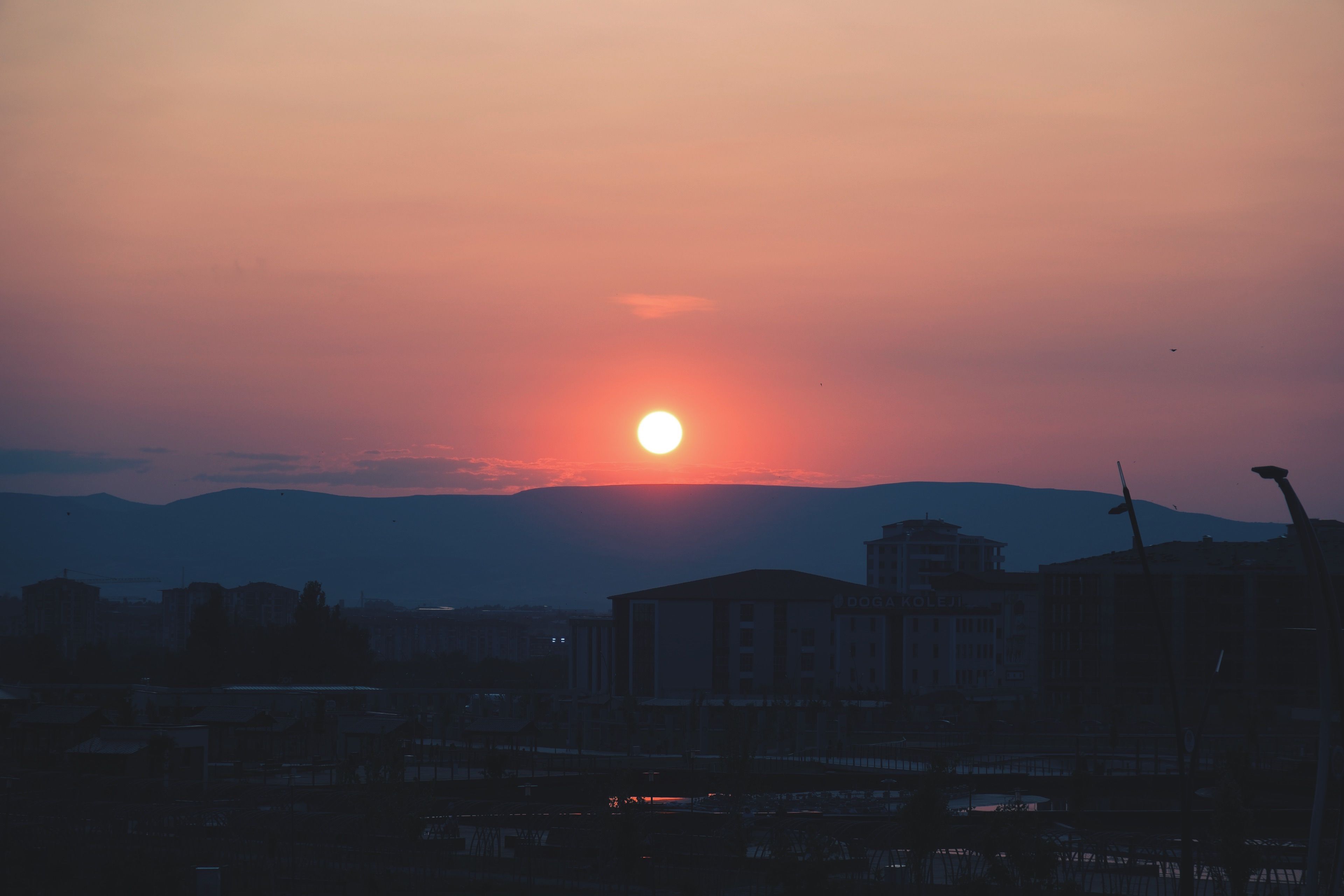 Sun setting behind the Ngong Hills seen from a Nairobi rooftop terrace