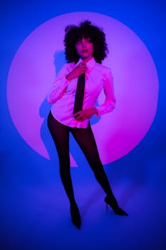 Chic portrait of a female model with vibrant neon lighting, showcasing modern fashion.