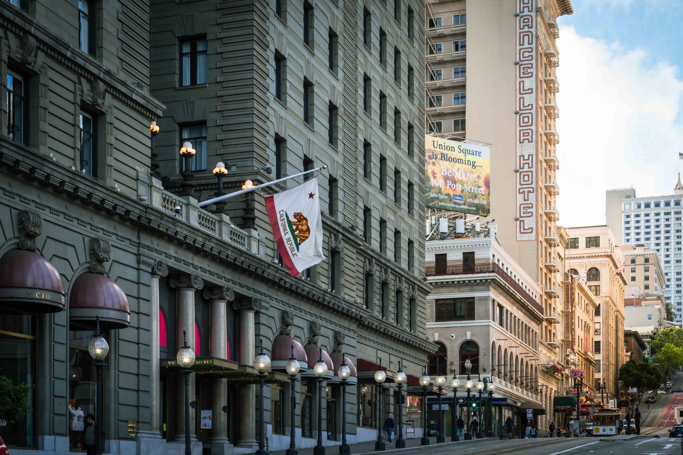Historic buildings and vibrant storefronts line Powell Street in San Francisco's Union Square.
