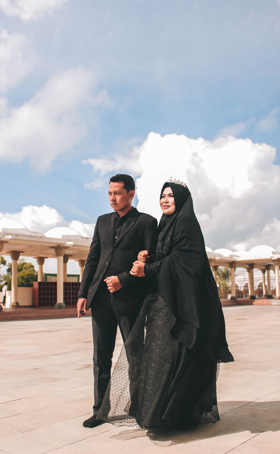 Woman Wearing Black Hijab Holding Man in Black Suit · Free Stock Photo