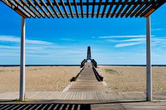 Experience the serene beach view at Le Barcarès with clear blue skies and sandy shores. Perfect travel escape.