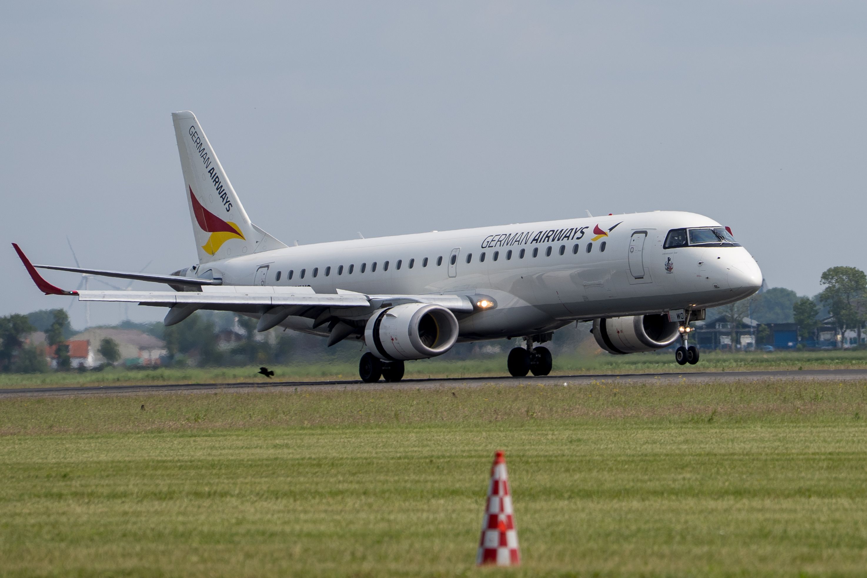 German Airways aircraft on the runway at an airport, ready for takeoff. (Photo by Martijn Stoof on Pexels)