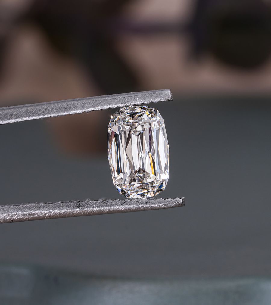 Lab-grown diamond held in tweezers