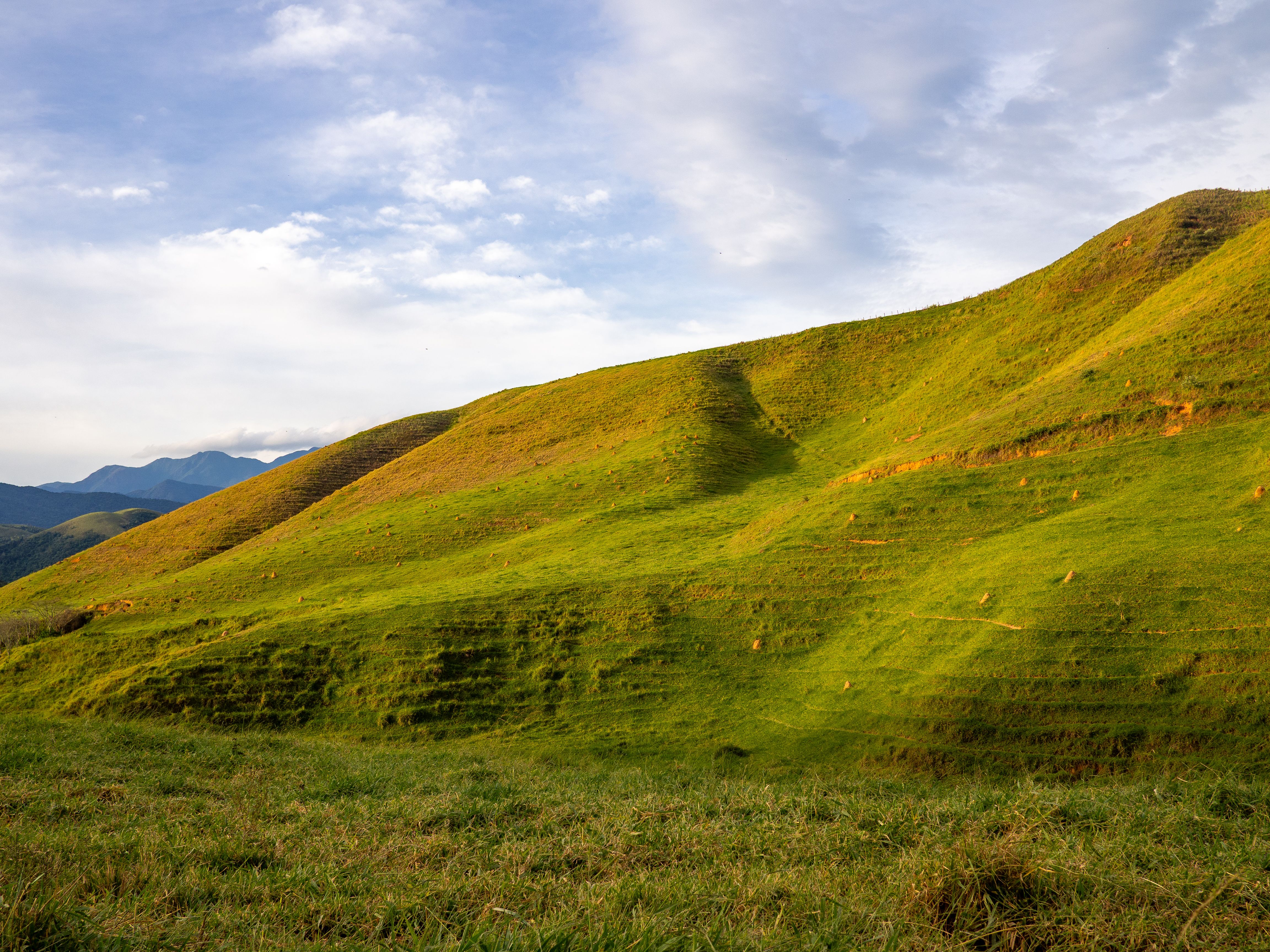 Scenic Green Hills Under a Vibrant Sky · Free Stock Photo