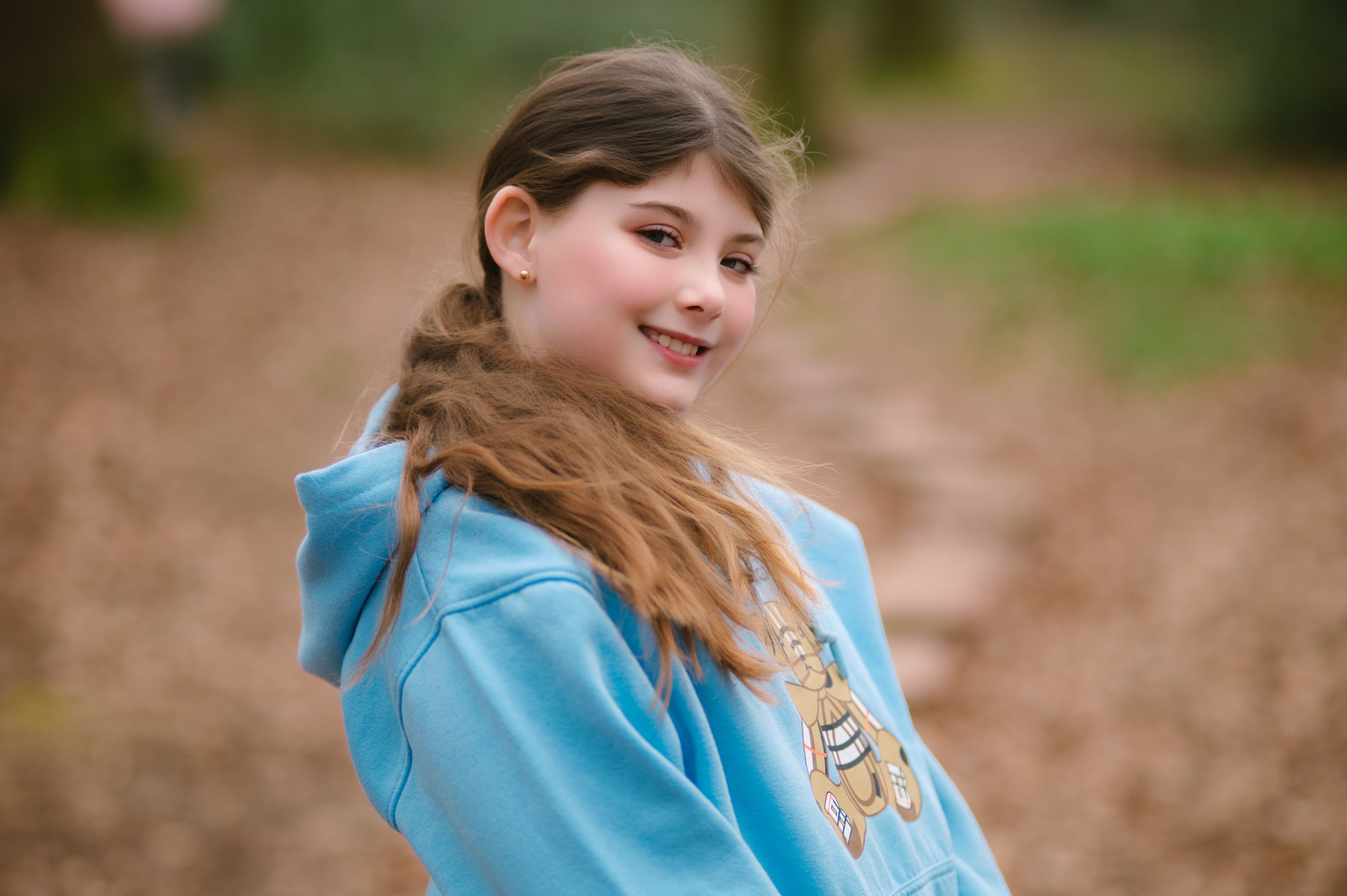 Smiling Girl in Blue Hoodie Outdoors · Free Stock Photo
