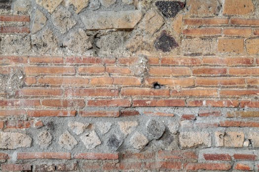 Close-up of an ancient Roman brick wall texture from Pompei, Italy, showcasing historical architecture.