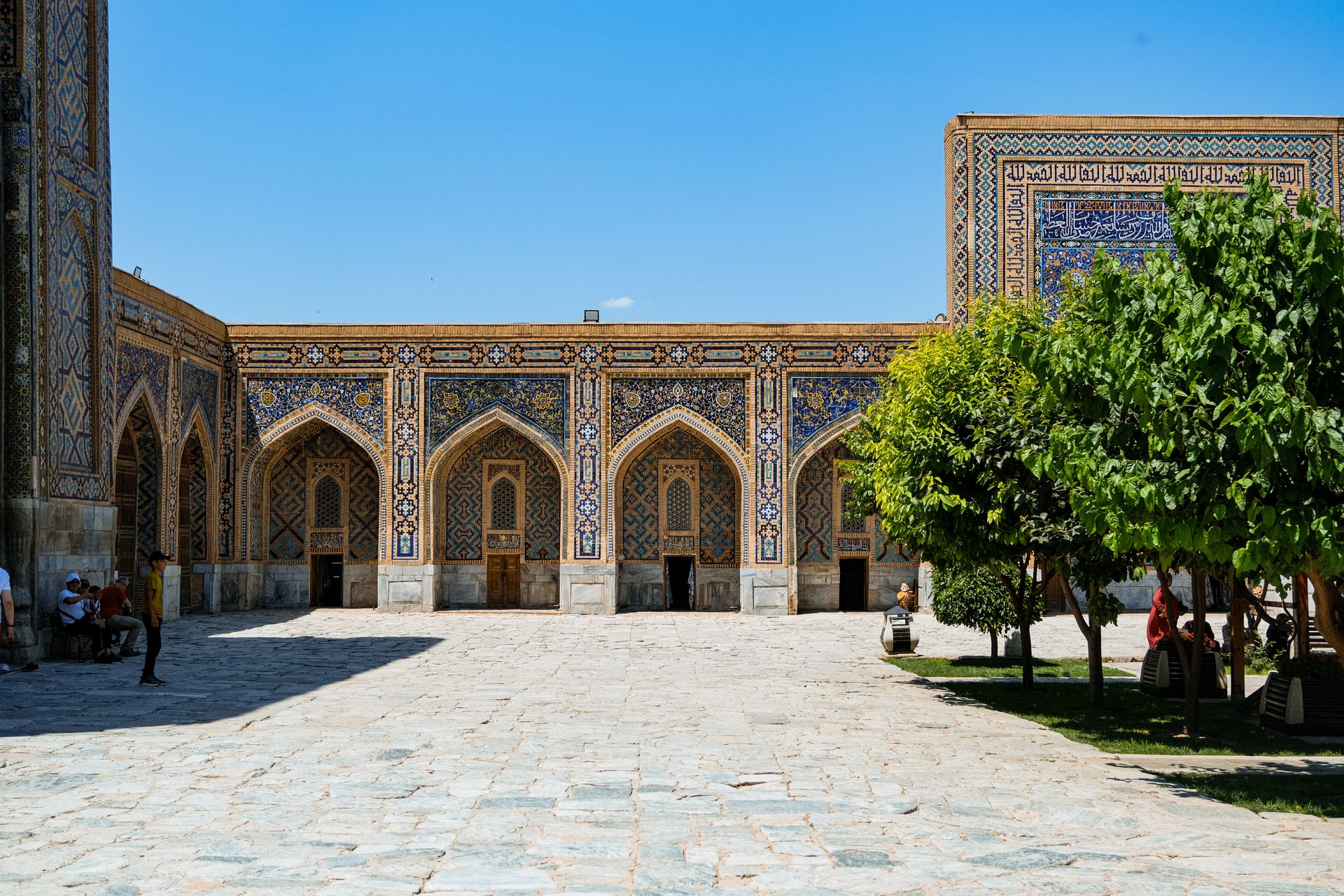 Explore the stunning courtyard of a historic mosque in Samarkand adorned with intricate tile work.
