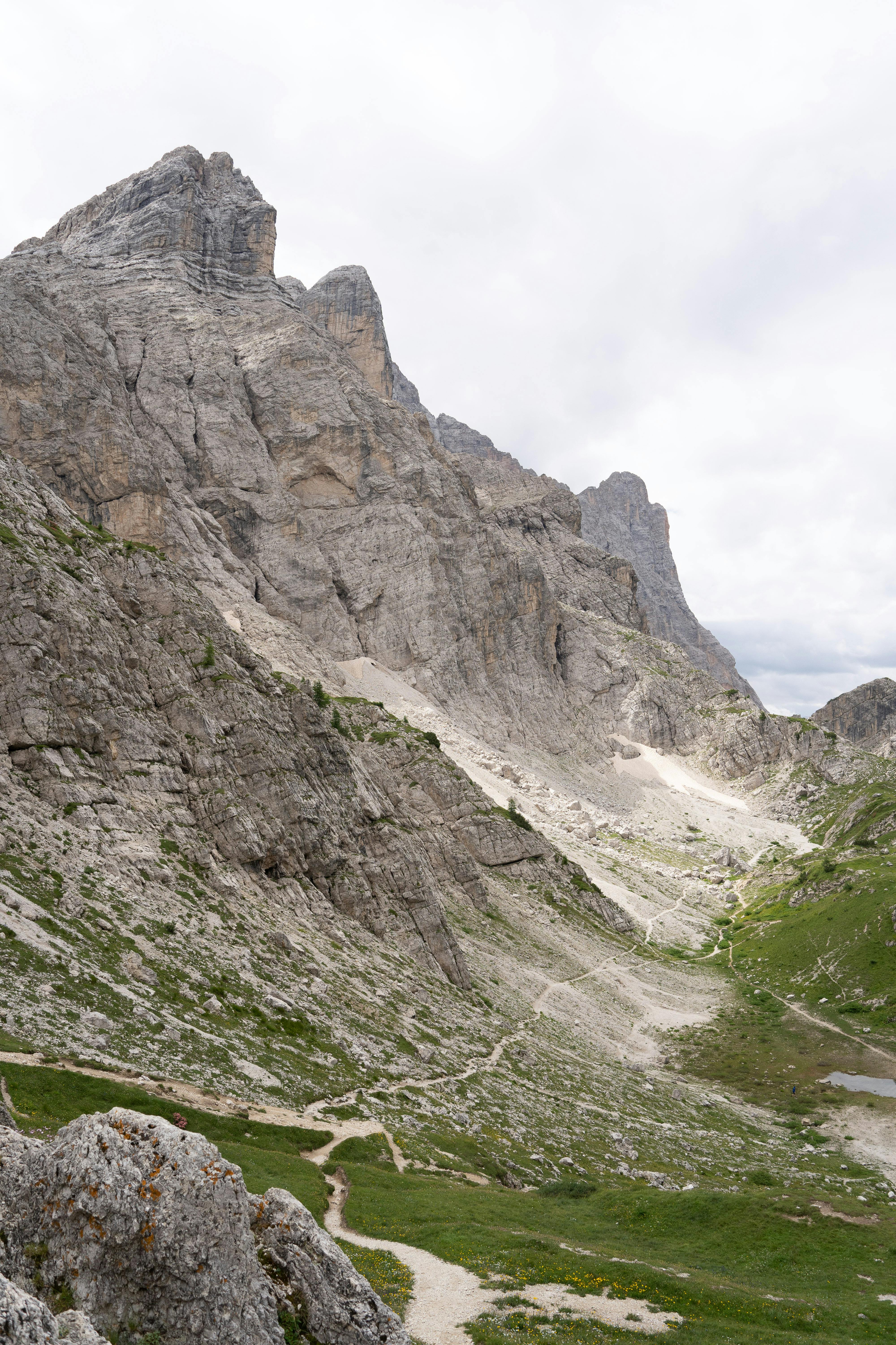Stunning mountain landscape in the Dolomites with rugged peaks and lush green valleys.