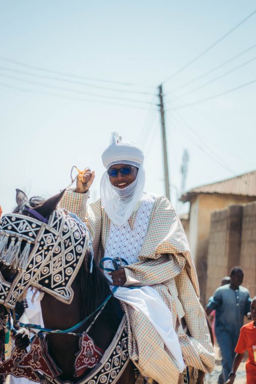 Free A traditional horseman dressed in ornate garb during a cultural festival in Nigeria. Stock Photo