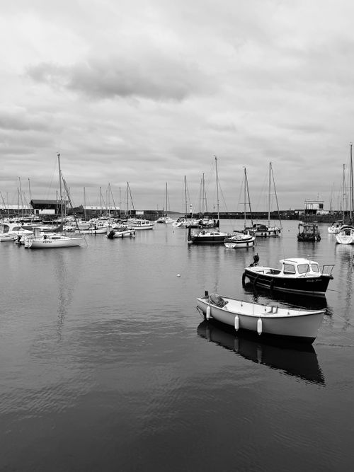 Free Black and white photo of Penzance harbor with boats and cloudy sky. Stock Photo