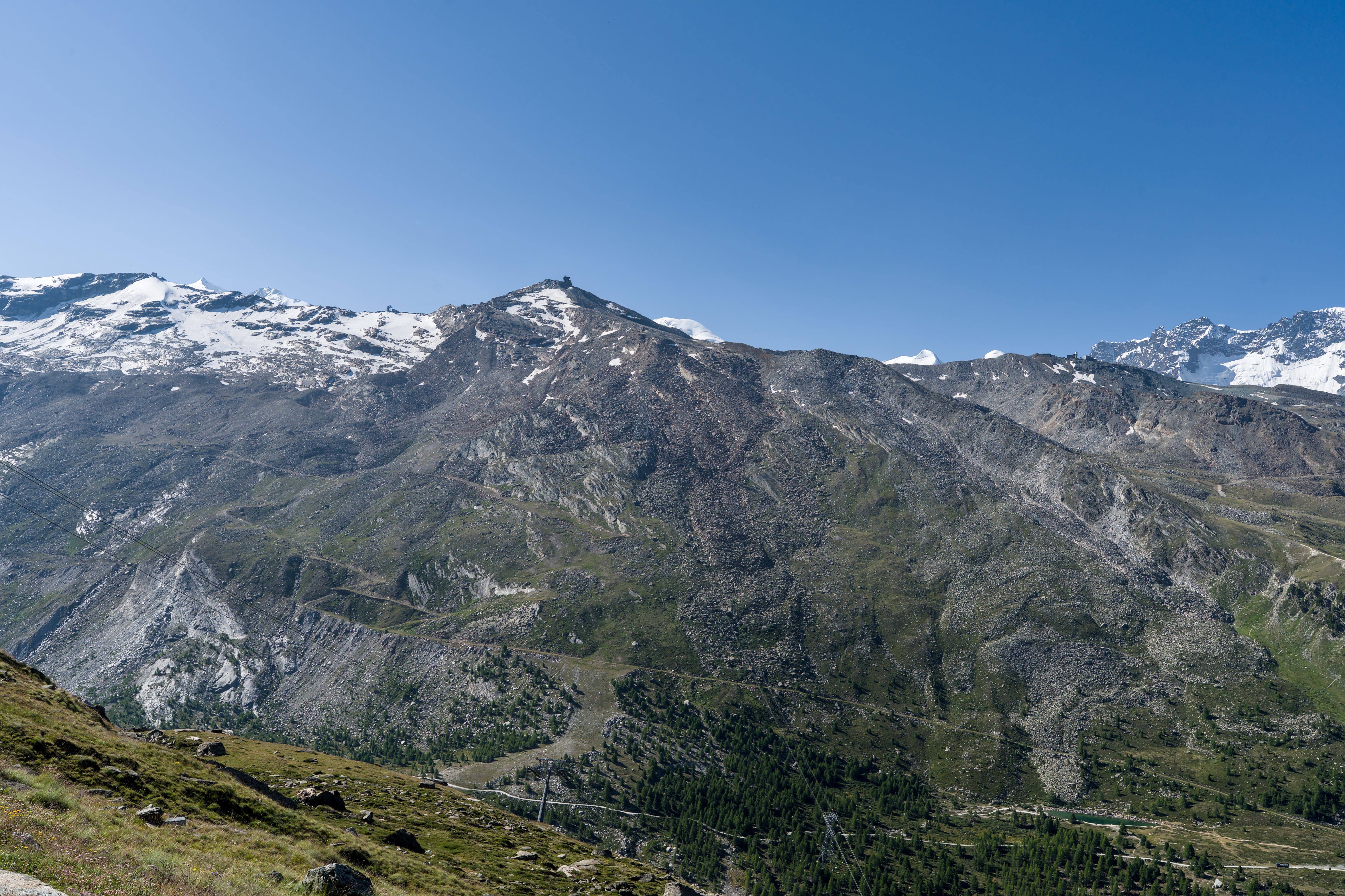 Breathtaking view of the Swiss Alps with clear blue skies near Zermatt, Switzerland.