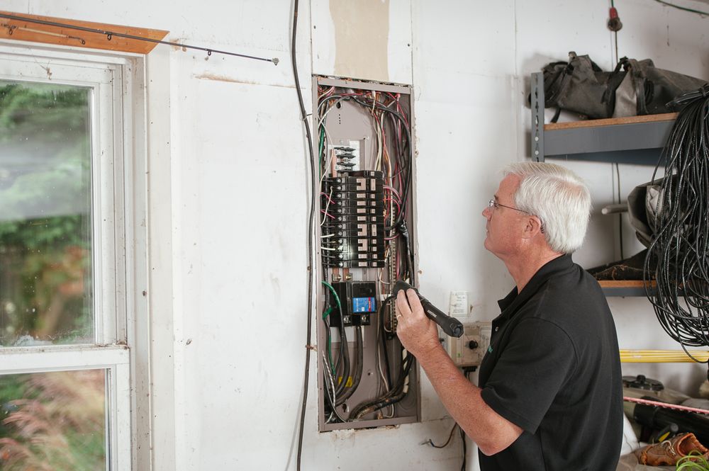 Electrician inspecting a residential breaker panel