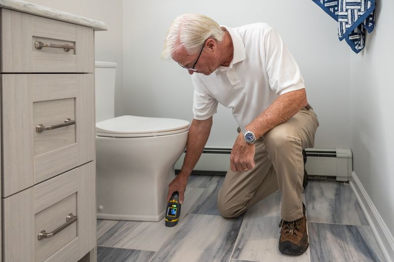 Plumber repairing toilet