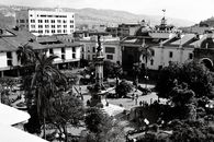 Black and white aerial view of Plaza Grande in Quito, showcasing colonial architecture and the bustling city atmosphere.