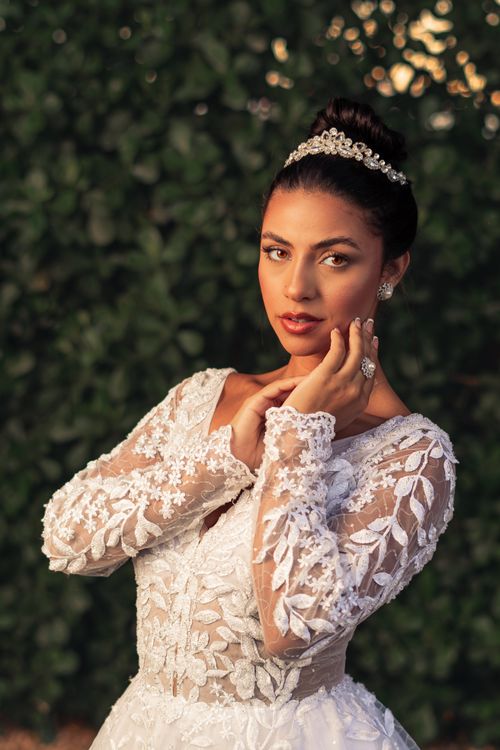 Free Stunning portrait of a bride in an elegant lace dress and tiara outdoors. Stock Photo
