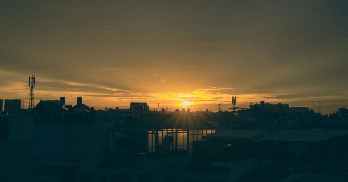 Sunset view from a rooftop bar overlooking Ho Chi Minh City skyline