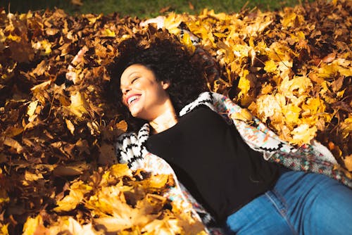 Woman Lying on Dry Leaves