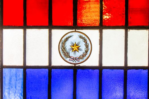 Stained glass in red, white, and blue featuring Paraguay's emblem. Symbol of patriotism in Asunciรณn.