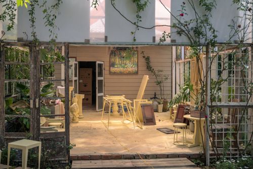 Free Explore a rustic indoor workshop surrounded by lush greenery and artistic decor. Stock Photo