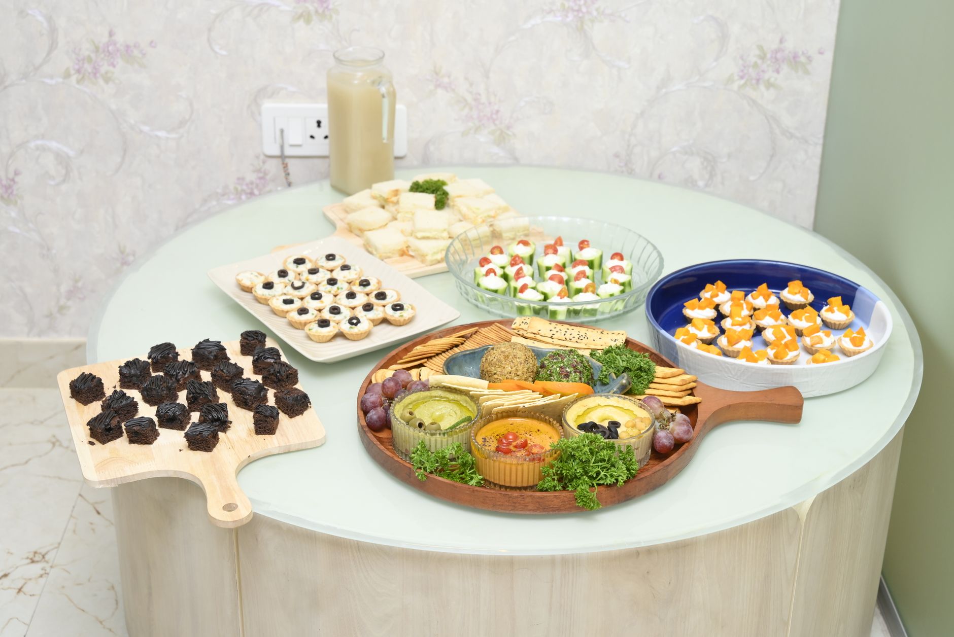 A diverse selection of appetizers on a round table ideal for parties.