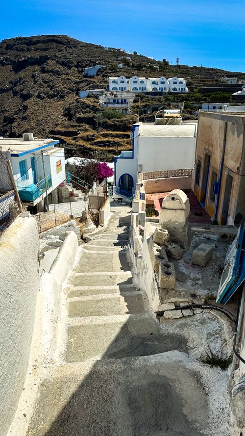 Free Discover a scenic stairway along traditional white houses in Santorini, capturing the island's beauty. Stock Photo