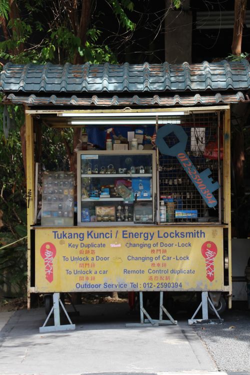 Free Outdoor locksmith kiosk with key cutting services, displaying tools and locks. Stock Photo