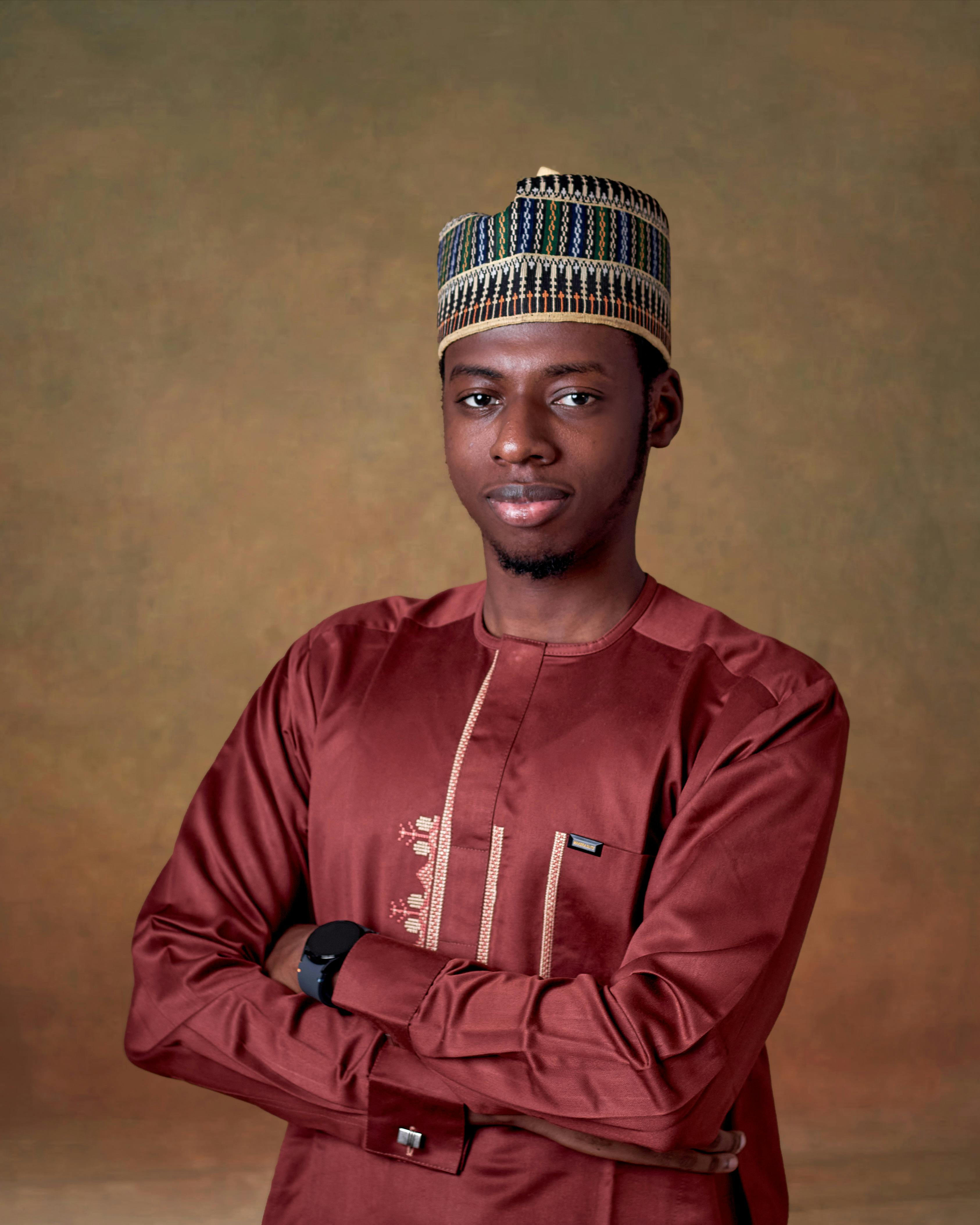 Young man wearing traditional Nigerian outfit with a confident smile.