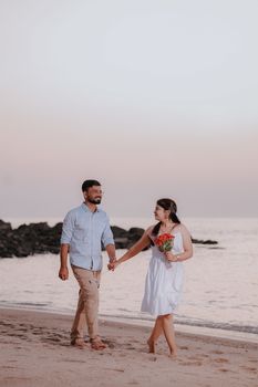 Couple holding hands on a serene beach during sunset in Mandvi, Gujarat. - Fotografer Sidoarjo