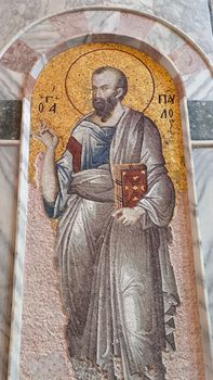 Detailed Byzantine mosaic depicting a saint with halo in architectural arch.